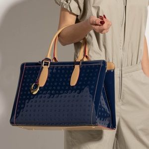 Arcadia navy blue embossed patent leather handbag.